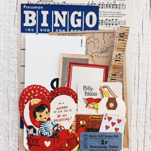 May include: A vintage Valentine's Day card featuring a red car with a boy and a dog inside. The card has the text "In a hurry to ask you to be my Valentine!" and is surrounded by other vintage paper ephemera, including a bingo card, a ruler, and a ticket.