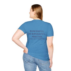 May include: A blue t-shirt with the words "POWERFUL. PURPOSEFUL. PRECISE. THE ROTTWEILER." printed in dark purple. The shirt is being worn by a person in blue jeans.