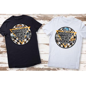 May include: Two t-shirts, one navy blue and one white, each with a circular graphic. The graphics feature monster trucks, the words "Monster Truck Dad" and "Monster Truck Mama", and a black and white checkered pattern.