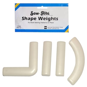May include: Off-white Sew-Rite Shape Weights for sewing patterns. The set includes three straight weights and one L-shaped weight, along with a curved weight. The packaging reads "Shape Weights To Hold Sewing Patterns In Place."