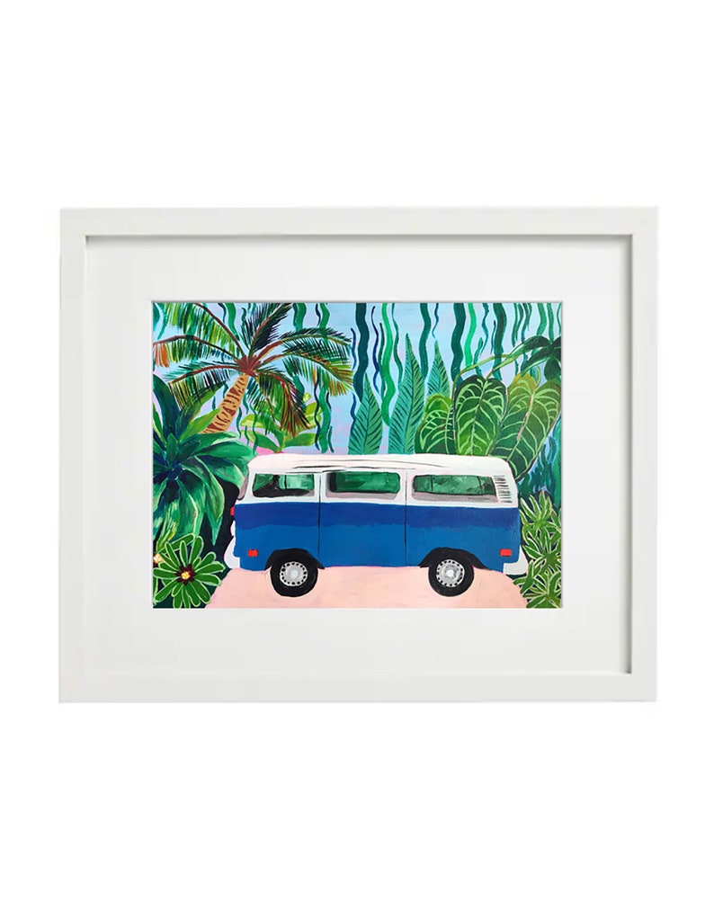 May include: A framed art print featuring a blue and white vintage van parked on a pink path, surrounded by lush green tropical foliage. The artwork is set against a light blue sky, creating a vibrant and cheerful scene.