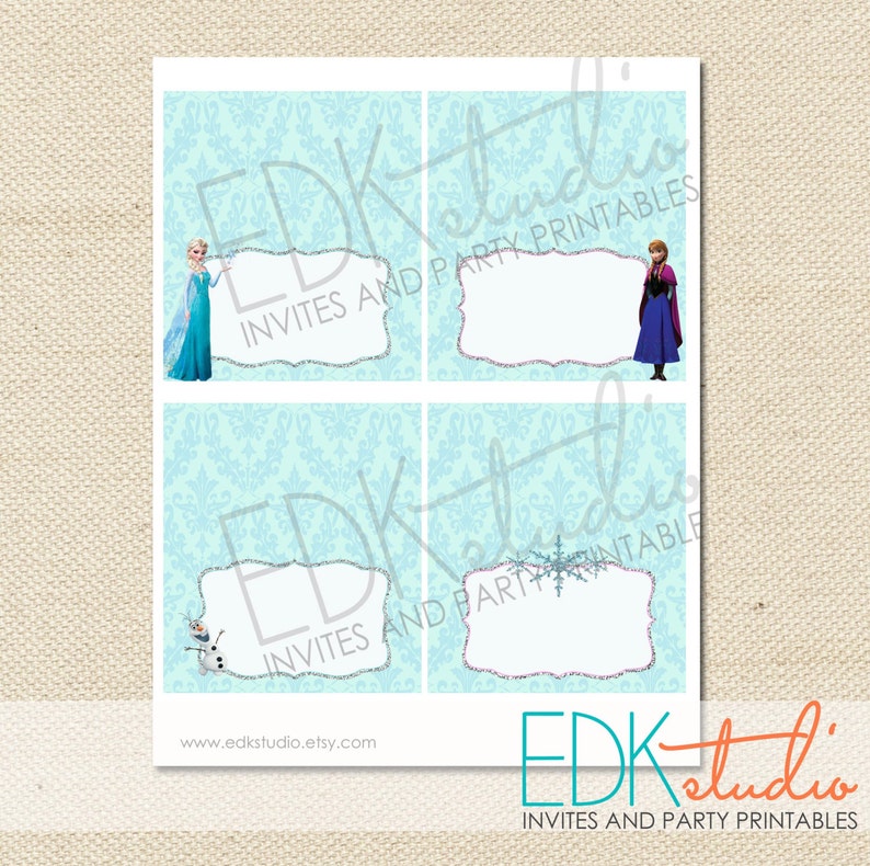 May include: Four printable place cards featuring characters from the movie Frozen. The cards are on a light blue background with a white damask pattern. The top left card features Elsa, the top right card features Anna, the bottom left card features Olaf, and the bottom right card features a snowflake.