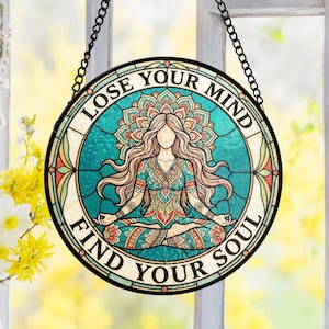 May include: Round stained glass art piece with a woman in a yoga pose, turquoise background, and the text "LOSE YOUR MIND FIND YOUR SOUL". The artwork is framed with a black metal chain for hanging.
