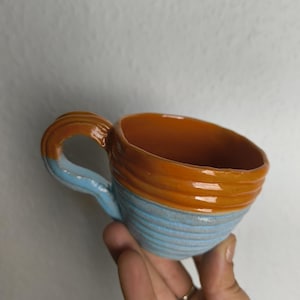 colorful handmade ceramic cups with handles