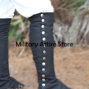 May include: A pair of black gaiters featuring a vertical row of silver-toned metal buttons along the outer side. The text Military Attire Store is visible across the center of the image. The gaiters are worn over white trousers.