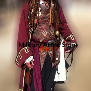 May include: A maroon long-sleeved coat with gold trim, worn over a patterned vest with paisley motifs. The outfit includes a brown leather belt with a metal buckle, black trousers, and a white fabric sash. The text Military Attire Store is visible.