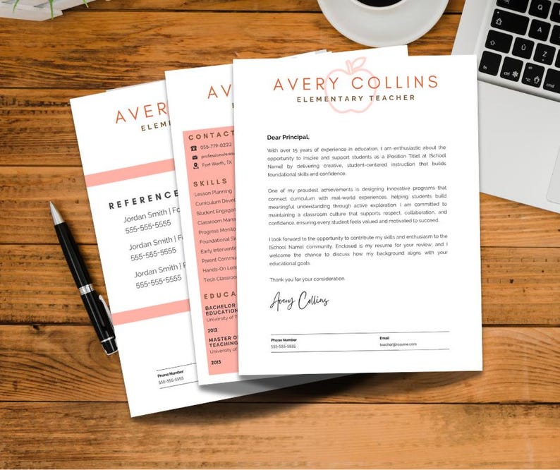 May include: A resume and reference documents are displayed on a wooden desk. The resume is titled "Avery Collins Elementary Teacher" with a pink apple logo. A black pen and a laptop are also visible.