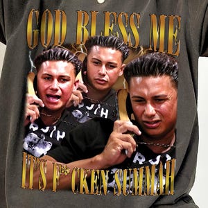 May include: Dark gray t-shirt with a graphic featuring three images of a man holding a phone, with the text "GOD BLESS ME" and "IT'S F*CKEN SEMMI". The shirt has a vintage, worn look.