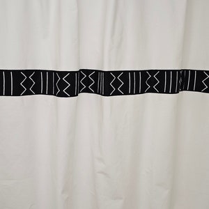 White cotton shower curtain accented with African print mudcloth