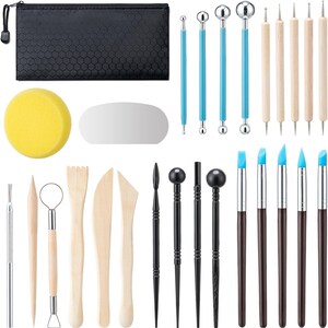 May include: A comprehensive pottery and sculpting tool set. Includes a black zippered case, a yellow sponge, a silver oval, and various tools with wooden, blue, and black handles. The set is designed for detailed work.