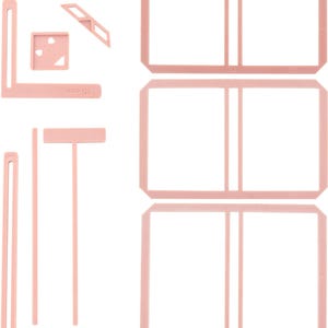 May include: A set of pink plastic craft tools for scrapbooking and card making. The set includes a ruler, a corner tool, a straight edge, and three different sized frames.