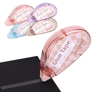 May include: A collection of colorful glue tape dispensers in pink, purple, blue, and tan. Each dispenser has a label that reads "Glue Tape" and "Size: 26ft x 0.31 inch". The brand name "Secopad" is also visible. One dispenser is shown in use, applying tape to a black surface.