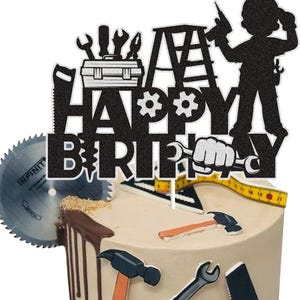 May include: A birthday cake with a construction theme. The cake is decorated with a black glittery "Happy Birthday" cake topper featuring tools, a ladder, and a silhouette of a construction worker. A circular saw blade is on the side.