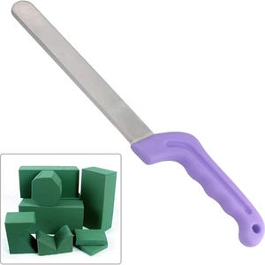 May include: A purple handled knife with a long, silver blade. The knife is used for cutting floral foam, which is shown in the background.