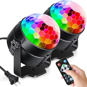 May include: Two black disco ball lights with a multi-coloured LED display and a remote control with LED buttons. The remote control has the word "LED" printed on it.