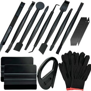 May include: A set of black tools, including a utility knife, various pry tools, squeegees, and a pair of black gloves with red trim. The tools are arranged on a white background.