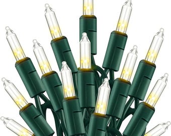 May include: A cluster of clear mini Christmas lights with a warm white glow. The bulbs are encased in clear glass and set on green wire. The lights are ideal for holiday decorating.