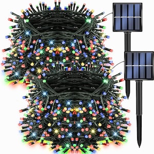 May include: A bundle of multi-colored LED string lights with a solar panel. The lights are red, green, blue, and yellow. The solar panel is black with a blue panel. The lights are on a black wire.