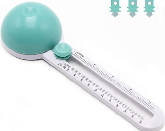 May include: A white and teal circle cutter with a teal circle guide and a ruler marked in inches and centimeters. The ruler goes up to 32 inches or 80 centimeters.  The circle cutter has a small teal knob to adjust the size of the circle.