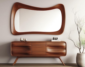 May include: A mid-century modern wooden dresser with a wavy design and three drawers. The dresser has a curved, wooden frame mirror above it.