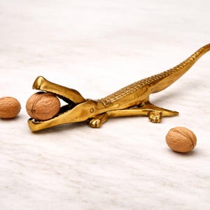 May include: A rustic wooden sign with the text "Welcome to our home" in white lettering. The sign features a distressed finish and a simple, inviting design, perfect for entryway decor.