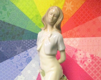 Vintage Porcelain Figurine of Young Lady Holding Flowers