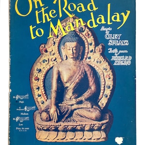 May include: Sheet music cover titled "On the Road to Mandalay" with a blue background. The cover features a seated Buddha statue in a decorative frame. Text includes the composer's name, Oley Speaks, and the poem's author, Rudyard Kipling.