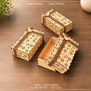 May include: Three rectangular light-colored wooden boxes with laser-cut floral patterns and heart-shaped accents on the lids. Two boxes are closed, and one is open, revealing the hollow interior. The text LaserCutFilesArts and Digital Download is visible.