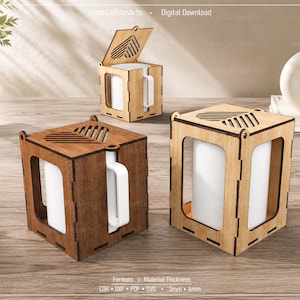 May include: Three square wooden mug holders with laser-cut heart patterns on the lids. One holder is dark brown, while two are light tan. Each features open sides and a white ceramic mug inside. Text at the bottom reads: Formats / Material Thickness CDR • DXF • PDF • SVG • 3mm • 4mm.
