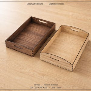 May include: Two rectangular wooden trays with cutout handles and finger-jointed corners. One tray is dark brown, and the other is light tan. Text at the top reads LaserCutFilesArts Digital Download, and at the bottom, Formats DXF PDF SVG 3mm 4mm.