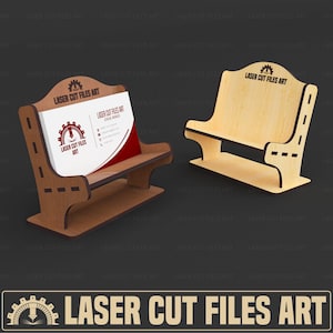 May include: Two wooden business card holders. One is filled with cards, the other is empty. The holders are made of light brown wood and have a bench-like design. The text "LASER CUT FILES ART" is visible on the holders.