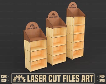 May include: Three wooden display shelves with a light brown finish. Each shelf has four levels and a top section with the text "LASER CUT FILES ART". The shelves are designed for laser cutting projects.