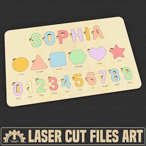 May include: Wooden puzzle board featuring the name "SOPHIA", shapes, and numbers. Shapes include a circle, triangle, square, hexagon, heart, and star. Numbers from zero to nine are also included. The puzzle is made of light-coloured wood.