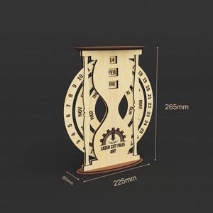 May include: A wooden hourglass-shaped calendar with a circular dial and date display. The calendar is 265mm tall, 225mm wide, and 60mm deep. The design includes the text "LASER CUT FILES ART". The calendar displays the date 14 FEB FRI.