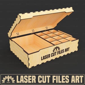 Puede incluir: Una caja de madera con tapa con bisagras, con múltiples compartimentos y el texto "LASER CUT FILES ART". La caja es de madera clara y tiene forma rectangular. La tapa está parcialmente abierta, revelando el interior.