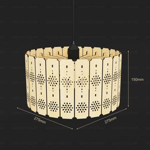 May include: A cylindrical pendant light shade constructed from light-colored wood panels featuring intricate laser-cut floral patterns. The shade measures 150mm in height and 275mm in diameter, suspended from a black cord and socket assembly.