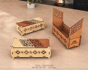 May include: Three rectangular wooden boxes with laser-cut geometric patterns on the lids and sides. Two boxes are closed, and one is open with upright side panels. The text "LASER CUT FILES ANY" is visible on the side of the open box.