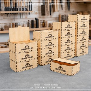 May include: A collection of light-coloured wooden storage boxes with hinged lids and interlocking finger joints. Each box features the text Laser Cut Files Art printed on the front. The boxes are arranged in stacks of varying heights on a flat surface.