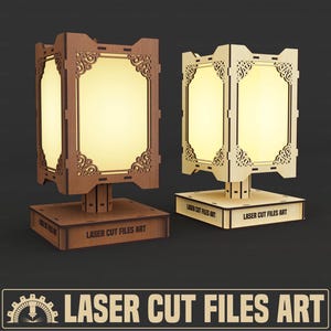 May include: Two wooden laser-cut lamps with illuminated rectangular shades. One lamp is a darker brown, the other is a lighter beige. Both have ornate corner designs and the text "LASER CUT FILES ART" on the base.