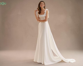 Elegante vestido de novia de crepé con escote cuadrado: vestido color marfil con espalda descubierta y lazo.