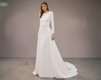 Elegante abito da sposa con scollo a barca: moderno con schiena scoperta e strascico removibile.