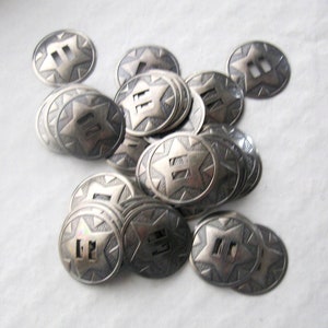 May include: A pile of silver-toned metal buttons with a star and the number "II" embossed on each button.