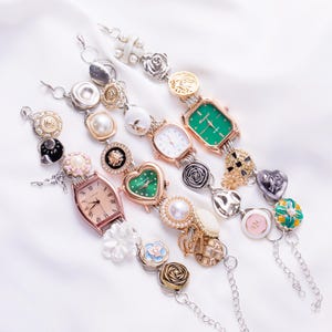 May include: Five charm bracelets with different colored watch faces and decorative charms. The charms include flowers, hearts, pearls, and other decorative elements.