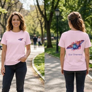 May include: A light pink short-sleeve t-shirt featuring a small watercolor butterfly graphic on the front left chest and a larger version of the same butterfly on the back with the text Rise Together printed in a dark blue script font below it.