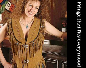 May include: A brown suede vest with fringe, decorative studs, and silver-toned buttons. The vest has a V-neck and is worn over a necklace with a turquoise pendant. Text on the side reads "Fringe that fits every mood."