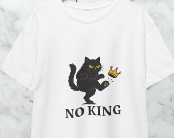 May include: White t-shirt featuring a black cat kicking a gold crown. The cat has yellow eyes and is standing on its hind legs. The text "NO KING" is printed below the cat in black, sans-serif font.