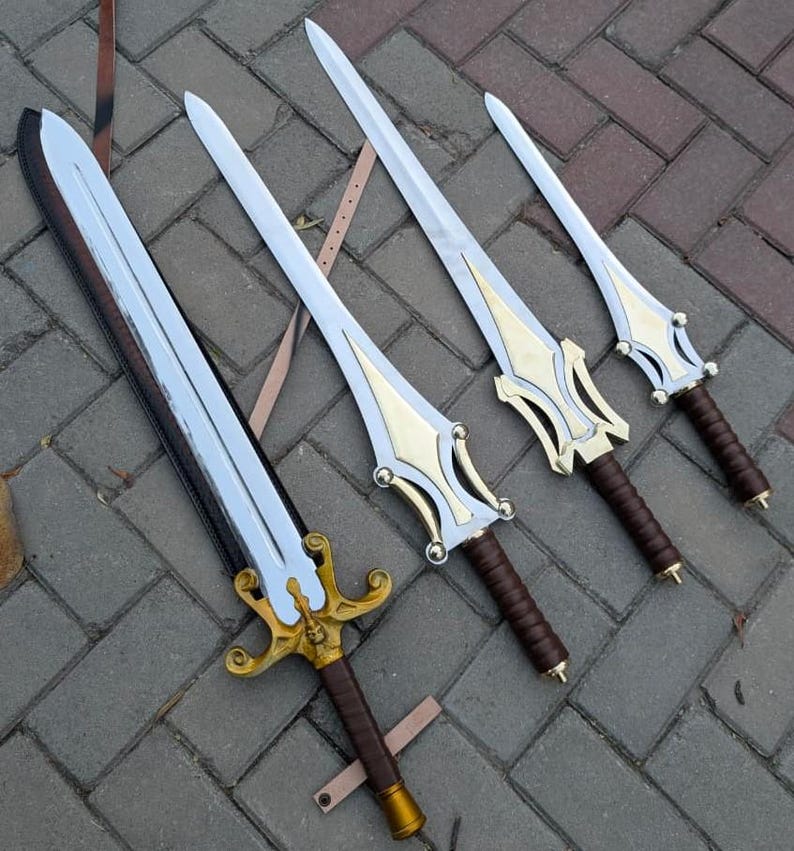 May include: Four fantasy swords with silver blades and gold-colored hilts. The handles are wrapped in brown leather. The swords are arranged on a gray brick surface, with leather straps visible.