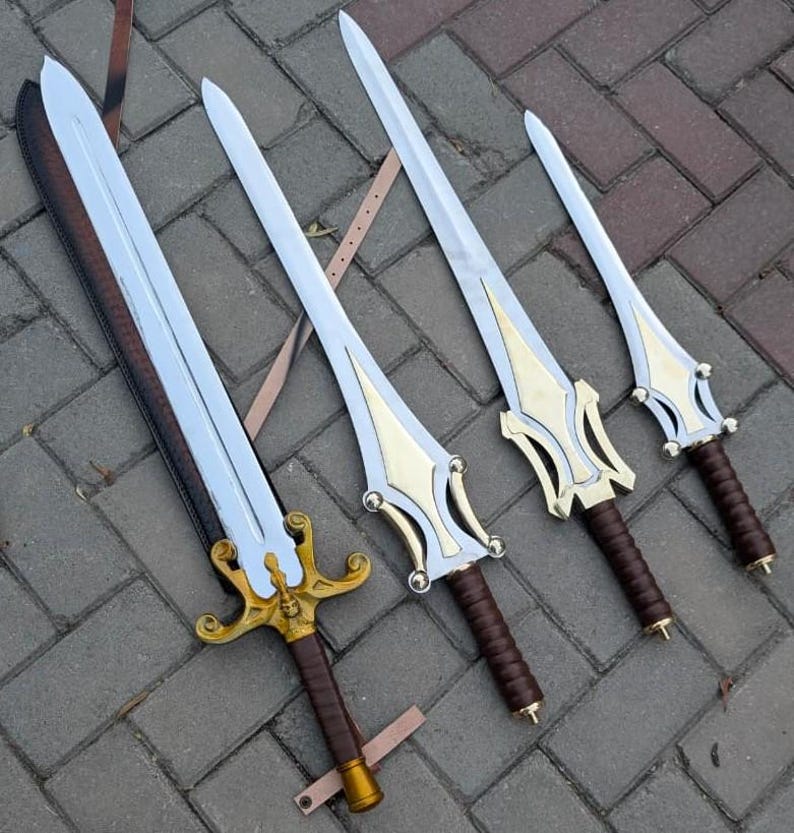 May include: Four decorative swords with silver blades and gold-colored hilts. The handles are wrapped in brown leather. The swords vary in size, with the largest one on the left. The swords are displayed on a gray brick surface.