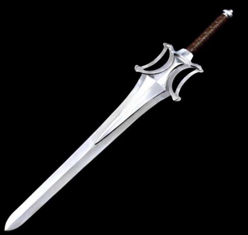 May include: A silver sword with a distinctive hilt design and a brown leather-wrapped handle. The blade is long and polished, reflecting light. The sword is set against a black background.