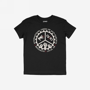 May include: Black t-shirt with a white and red graphic. The graphic shows a gear with a megaphone, chains, and fists, and the text "INTERNATIONAL UNION OF ANTI-FASCISTS BROOKLYN LOCAL 718". The word "STRANGE" is printed at the top.